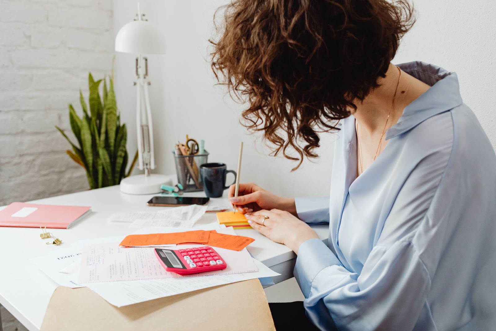 Working out the cost of a bathroom project at a desk.